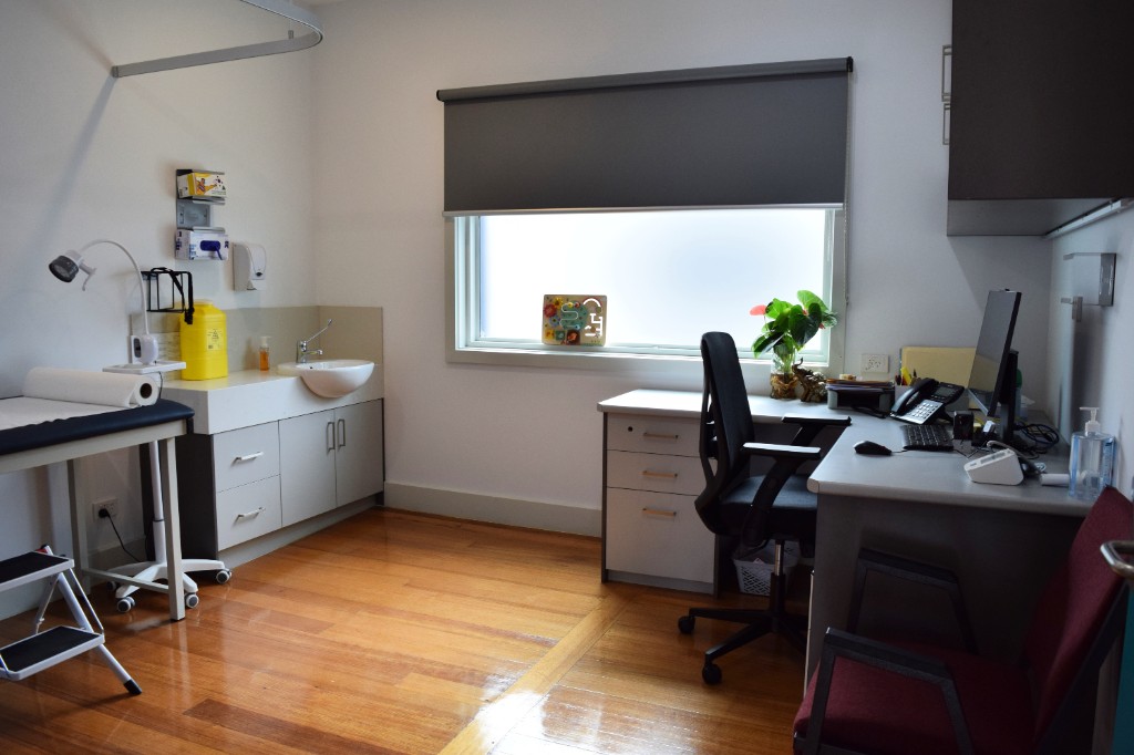 Examination room with desk and natural light at Sunrise Family Medical Centre
